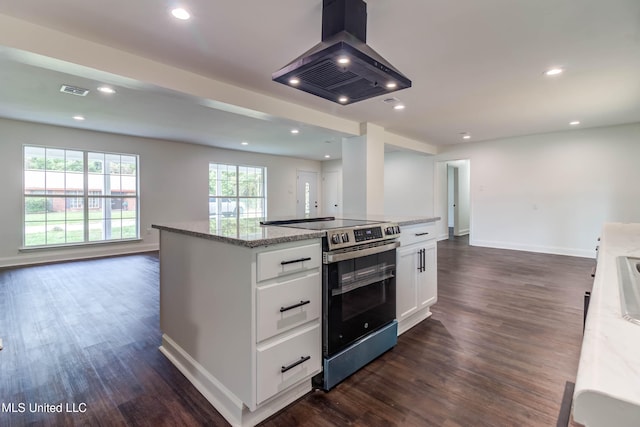 kitchen featuring light stone counters, island range hood, white cabinets, a center island, and stainless steel electric range oven