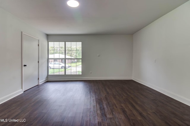 empty room featuring dark wood-type flooring