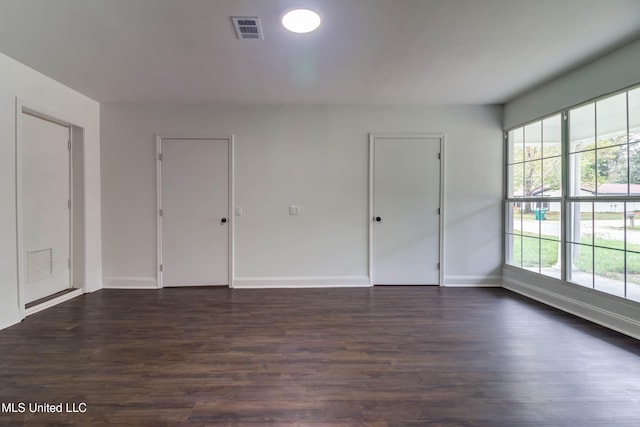 empty room with dark wood-type flooring