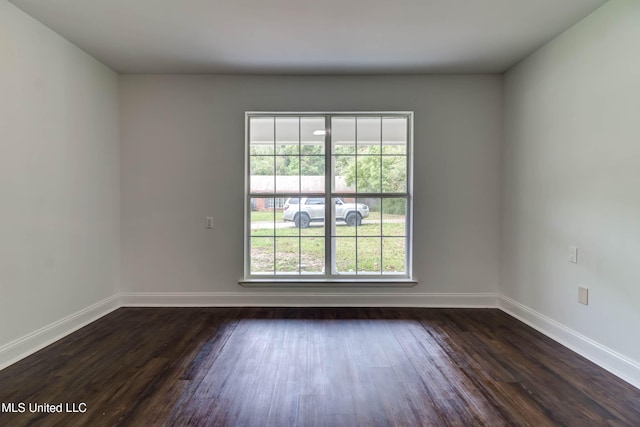 spare room featuring dark hardwood / wood-style flooring