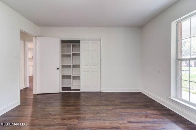 12394 Cypress Dr, Gulfport, MS 39503 - unfurnished bedroom featuring dark wood-type flooring, baseboards, and a closet
