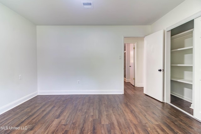 12394 Cypress Dr, Gulfport, MS 39503 - unfurnished bedroom featuring dark wood-type flooring, baseboards, and a closet