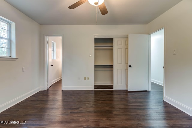 unfurnished bedroom featuring a closet, ceiling fan, and dark wood-type flooring