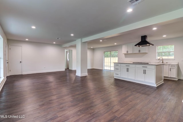 12394 Cypress Dr, Gulfport, MS 39503 - unfurnished living room featuring plenty of natural light, dark wood-style flooring, baseboards, recessed lighting, and a sink