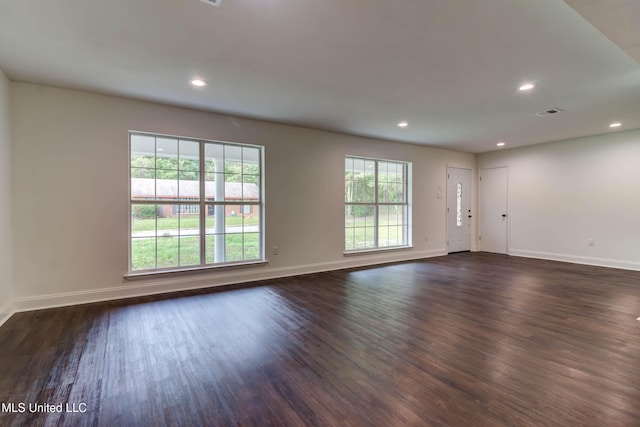 unfurnished room with dark hardwood / wood-style floors