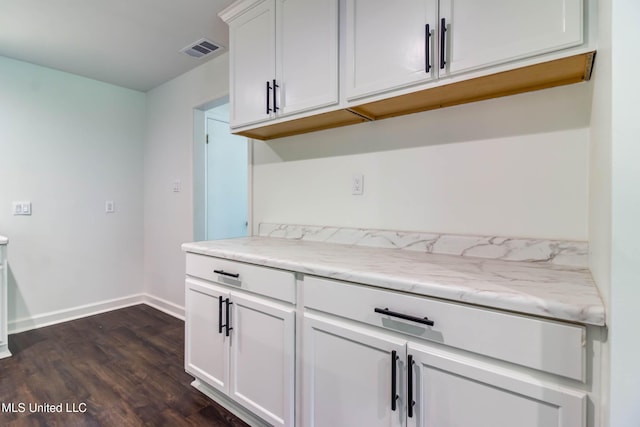 12394 Cypress Dr, Gulfport, MS 39503 - kitchen featuring dark wood-type flooring, baseboards, white cabinets, and light stone countertops
