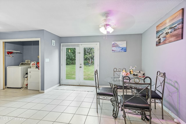 tiled dining space featuring french doors and washing machine and clothes dryer