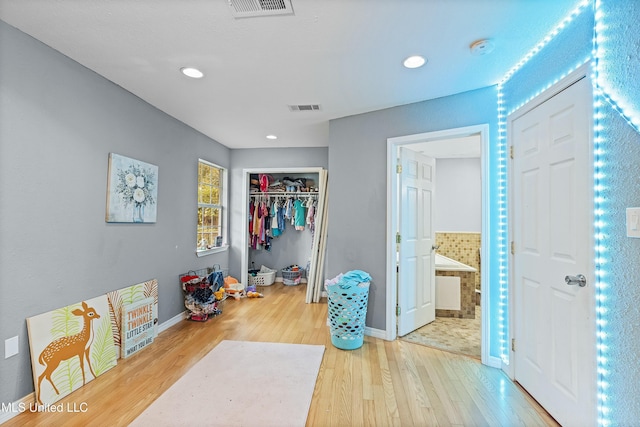 hall with hardwood / wood-style floors