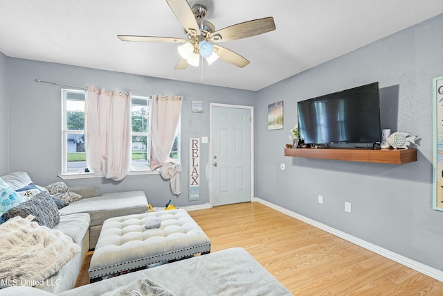 living room with hardwood / wood-style floors and ceiling fan