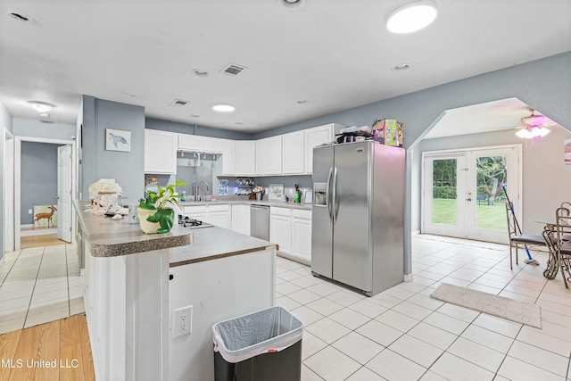 kitchen featuring french doors, sink, white cabinetry, light tile patterned floors, and appliances with stainless steel finishes