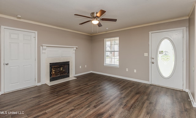 foyer entrance with dark hardwood / wood-style floors, ceiling fan, crown molding, and a premium fireplace