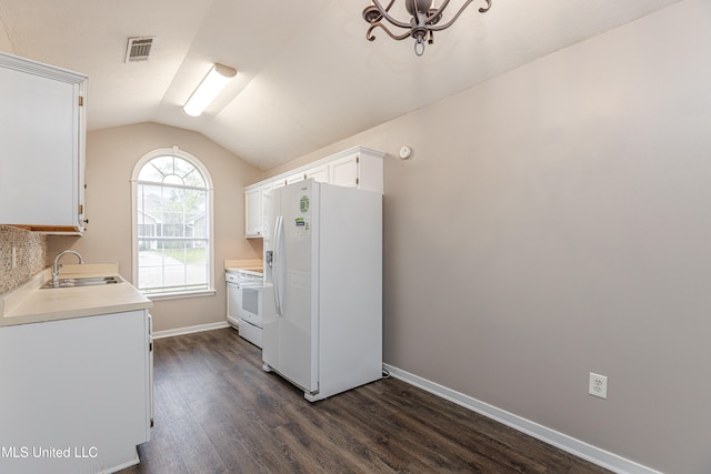 kitchen featuring white appliances, white cabinets, sink, vaulted ceiling, and dark hardwood / wood-style floors