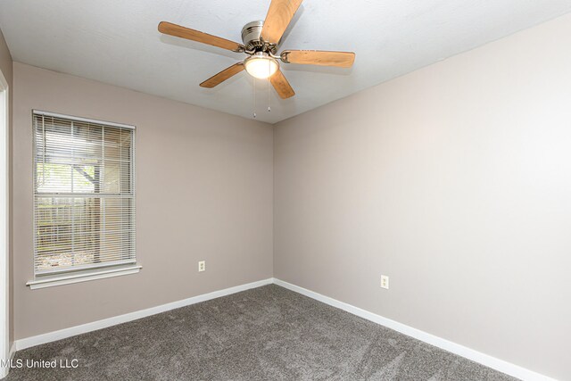 spare room featuring carpet flooring and ceiling fan