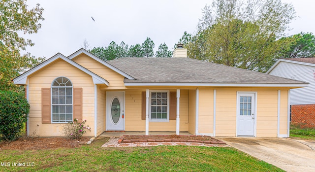 view of front of property with covered porch and a front lawn