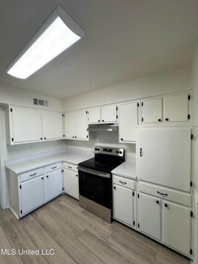 kitchen featuring white cabinetry, stainless steel electric stove, and light hardwood / wood-style flooring