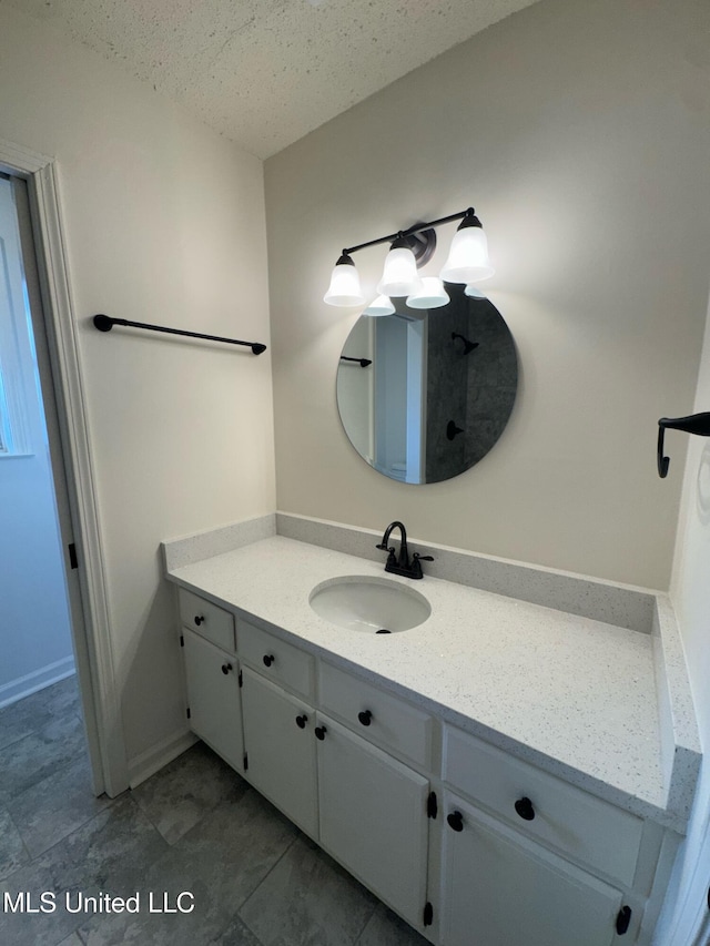 bathroom with vanity and a textured ceiling