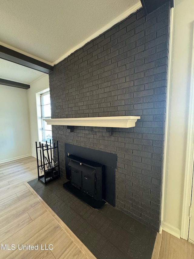 details featuring hardwood / wood-style floors, ornamental molding, and a textured ceiling