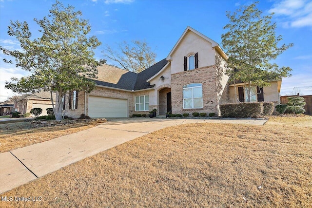 view of front property with a garage and a front yard