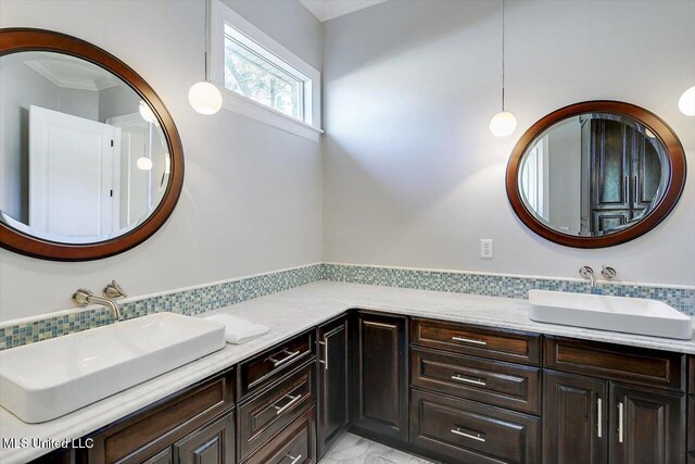 bathroom featuring vanity and ornamental molding