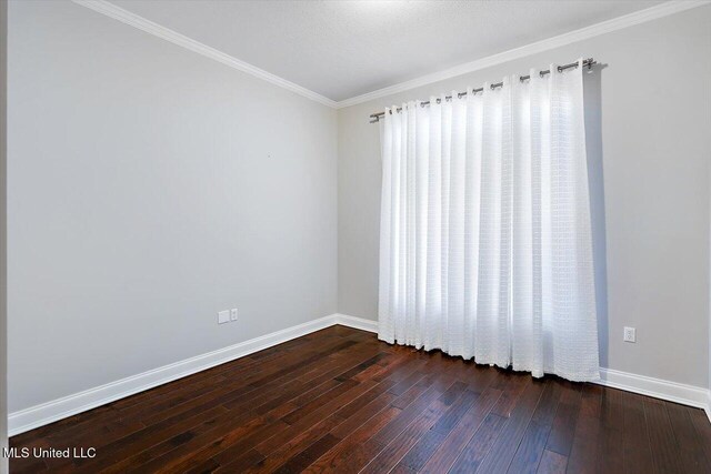 unfurnished room with dark wood-type flooring, a textured ceiling, and ornamental molding