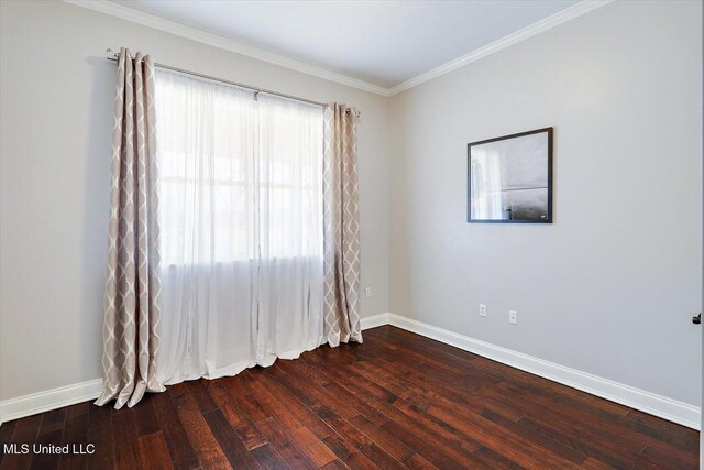 unfurnished room with crown molding and wood-type flooring