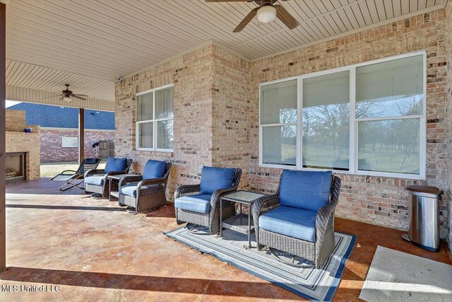 view of patio / terrace featuring a fireplace and ceiling fan