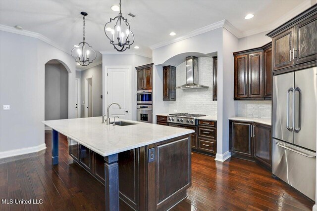 kitchen with a kitchen island with sink, wall chimney range hood, sink, dark hardwood / wood-style floors, and stainless steel appliances