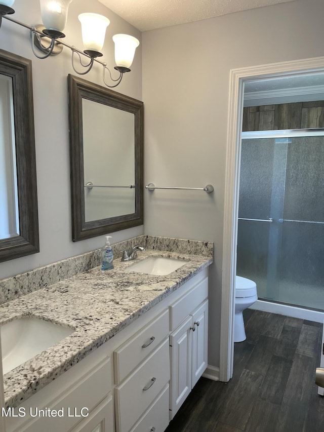 130 Eastwood Cir, Florence, MS 39073 - full bathroom featuring double vanity, wood finished floors, and a stall shower