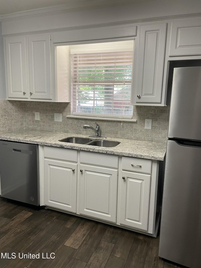 130 Eastwood Cir, Florence, MS 39073 - kitchen with stainless steel appliances, white cabinets, tasteful backsplash, crown molding, and dark wood finished floors