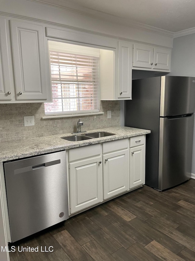130 Eastwood Cir, Florence, MS 39073 - kitchen with appliances with stainless steel finishes, crown molding, white cabinetry, tasteful backsplash, and dark wood-style floors