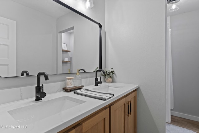 bathroom featuring vanity and hardwood / wood-style floors