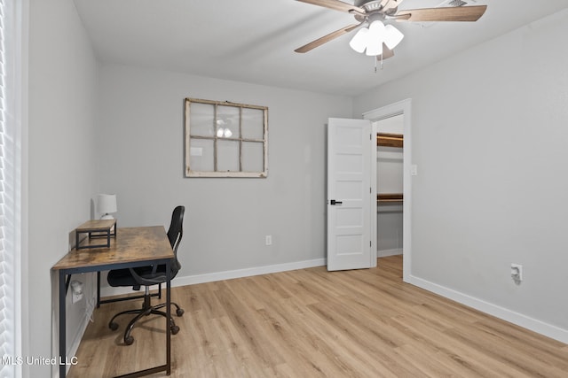 office area with light hardwood / wood-style floors and ceiling fan