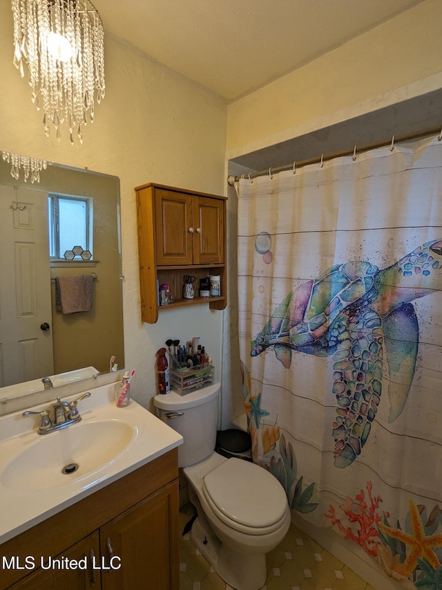 3607 Pentagon Dr, Pascagoula, MS 39581 - bathroom with vanity, toilet, a chandelier, and a shower with shower curtain