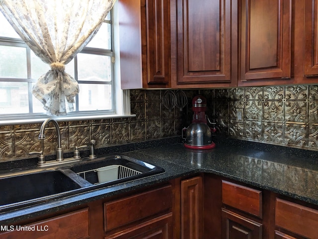 3607 Pentagon Dr, Pascagoula, MS 39581 - kitchen featuring a sink, backsplash, and dark stone countertops
