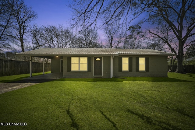 single story home with an attached carport, a front lawn, fence, and brick siding