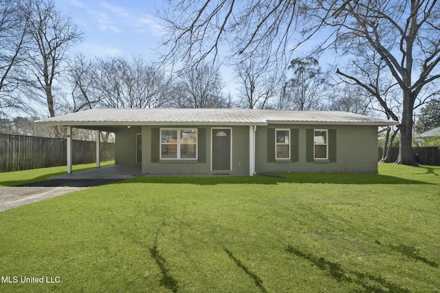 ranch-style house featuring brick siding, metal roof, a front lawn, and fence