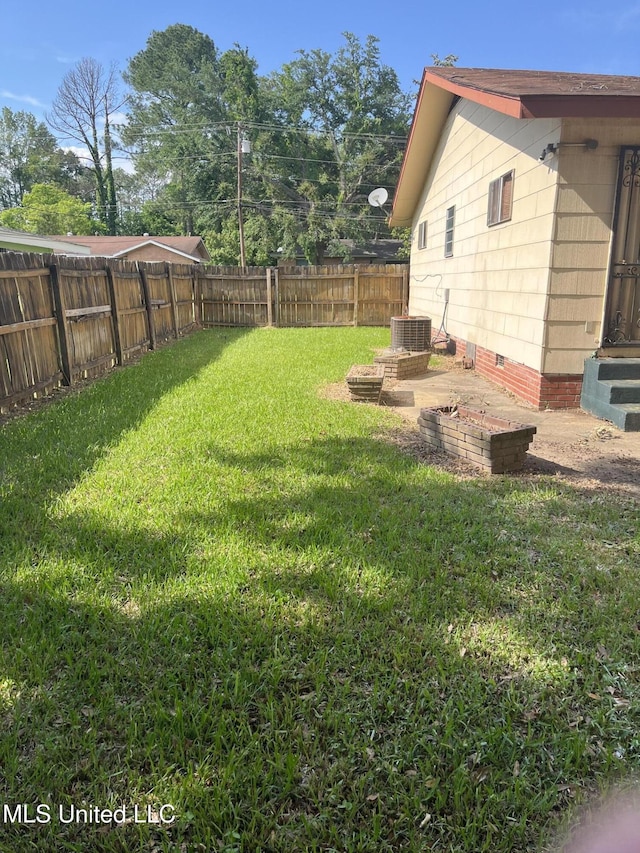 view of yard featuring a fenced backyard and central AC unit