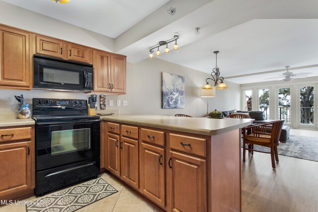 kitchen with black appliances, kitchen peninsula, pendant lighting, and ceiling fan with notable chandelier