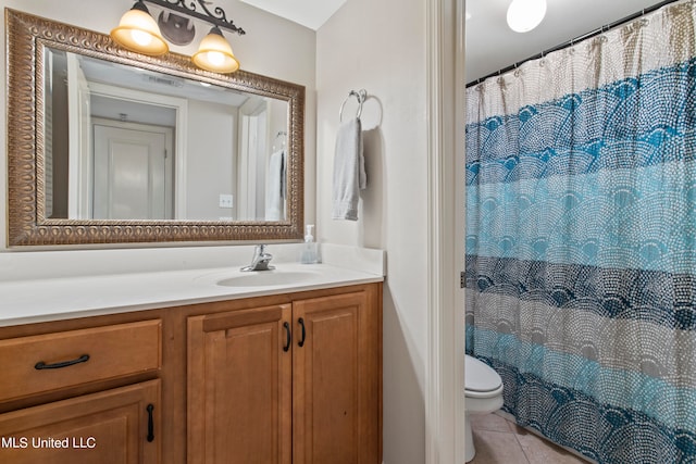 bathroom with vanity, curtained shower, toilet, and tile patterned flooring