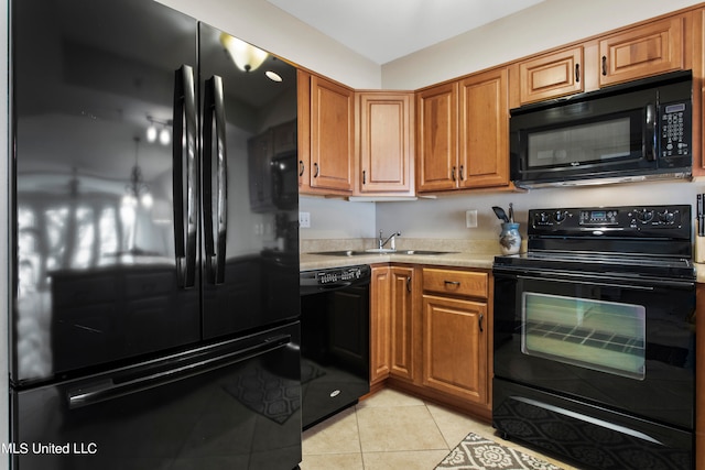 kitchen with light tile patterned flooring, black appliances, and sink