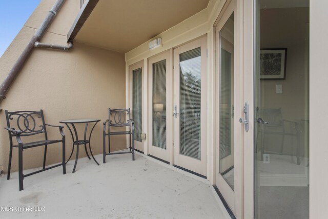 balcony with french doors and a patio