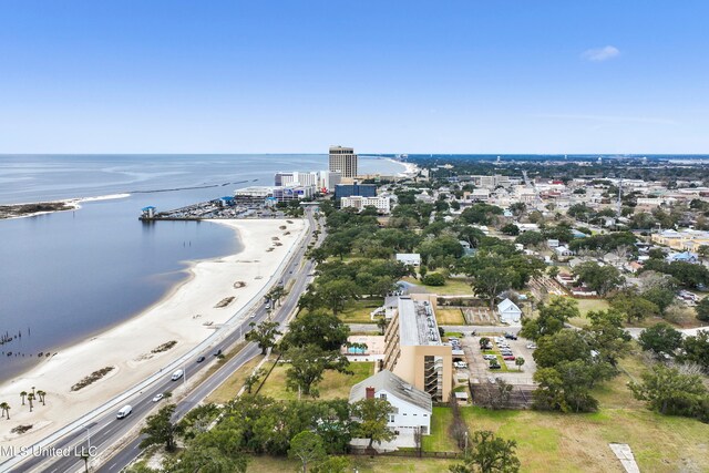 drone / aerial view with a water view and a beach view