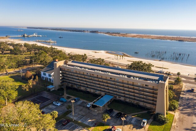 drone / aerial view featuring a water view and a beach view