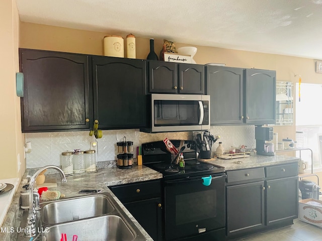 kitchen featuring black range with electric stovetop, sink, a wealth of natural light, and tasteful backsplash