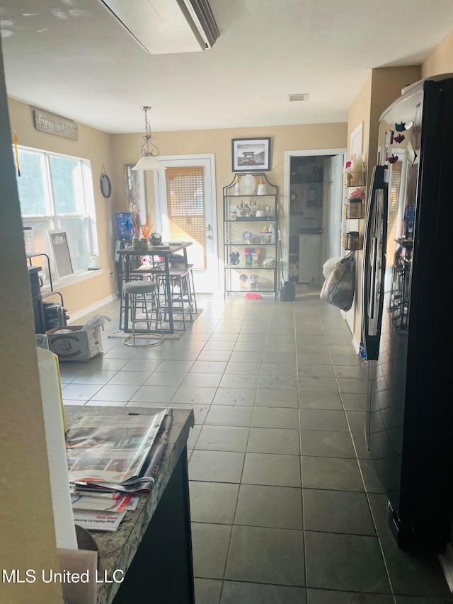 hallway with tile patterned flooring