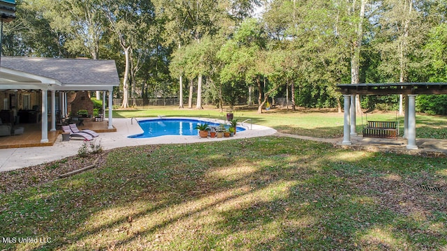 view of pool featuring a yard and a patio area