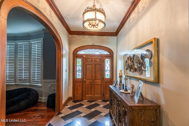 entryway featuring ornamental molding and dark hardwood / wood-style floors