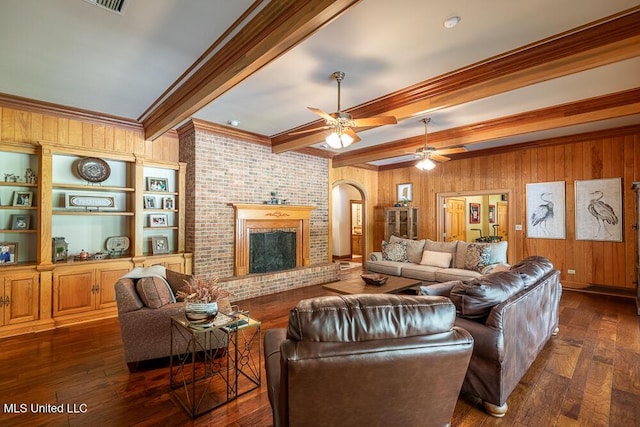 305 Creekbend Rd, Natchez, MS 39120 - living room with beam ceiling, wood walls, dark wood-type flooring, arched walkways, and crown molding