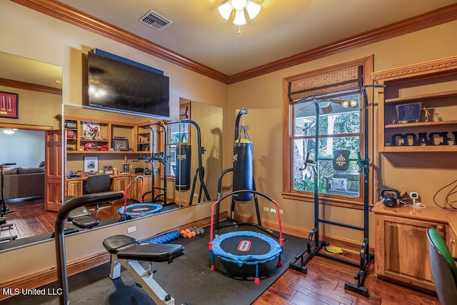 workout area featuring wood-type flooring, ceiling fan, and crown molding