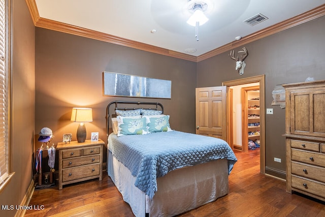 bedroom featuring ceiling fan, dark hardwood / wood-style flooring, and ornamental molding